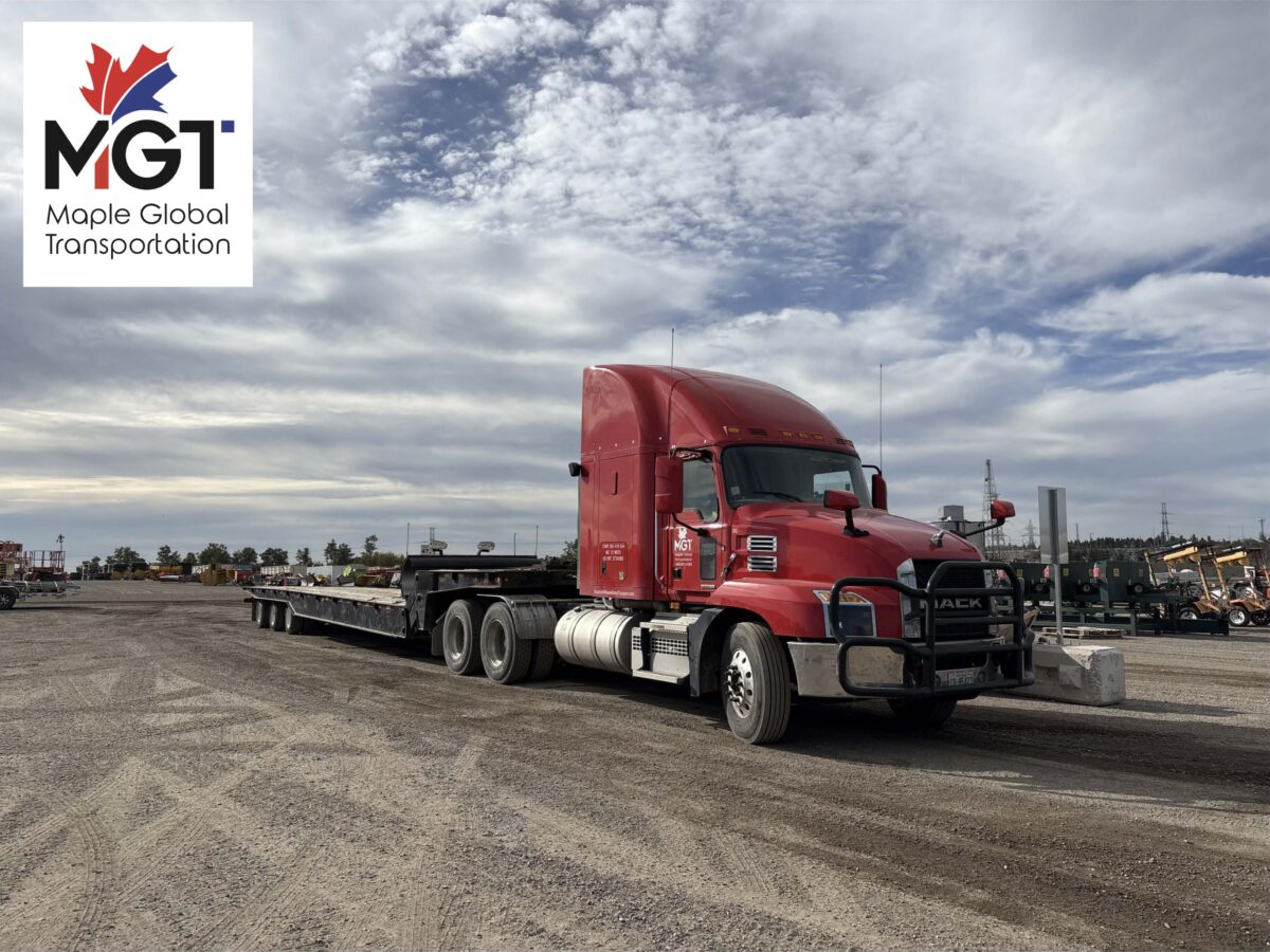 MGT flatbed truck transporting industrial equipment in Ontario